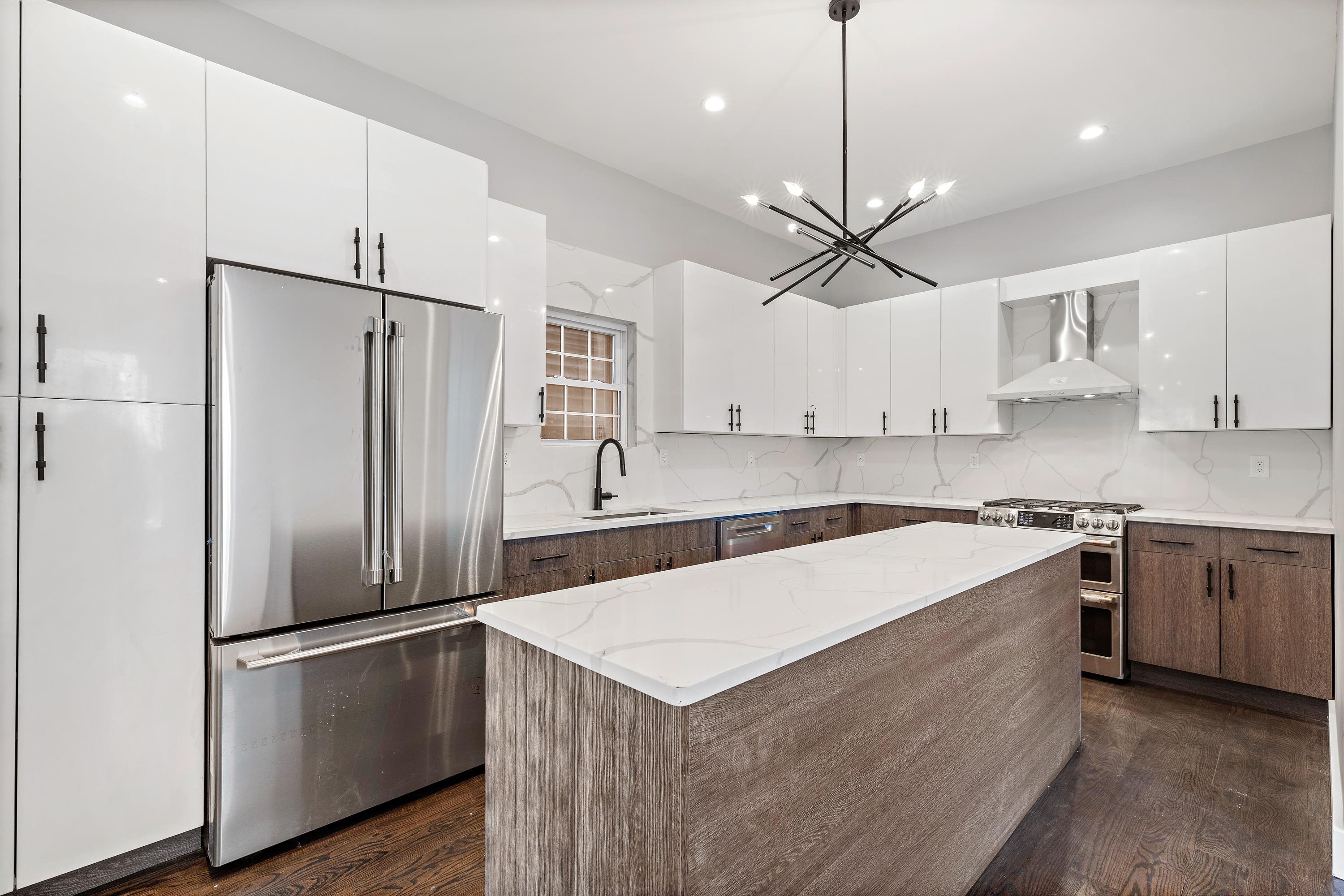 189 Hackensack Plank Road Weehawken, NJ 07086 - Photo 24 of 46 a kitchen with stainless steel appliances a refrigerator a sink and a stove