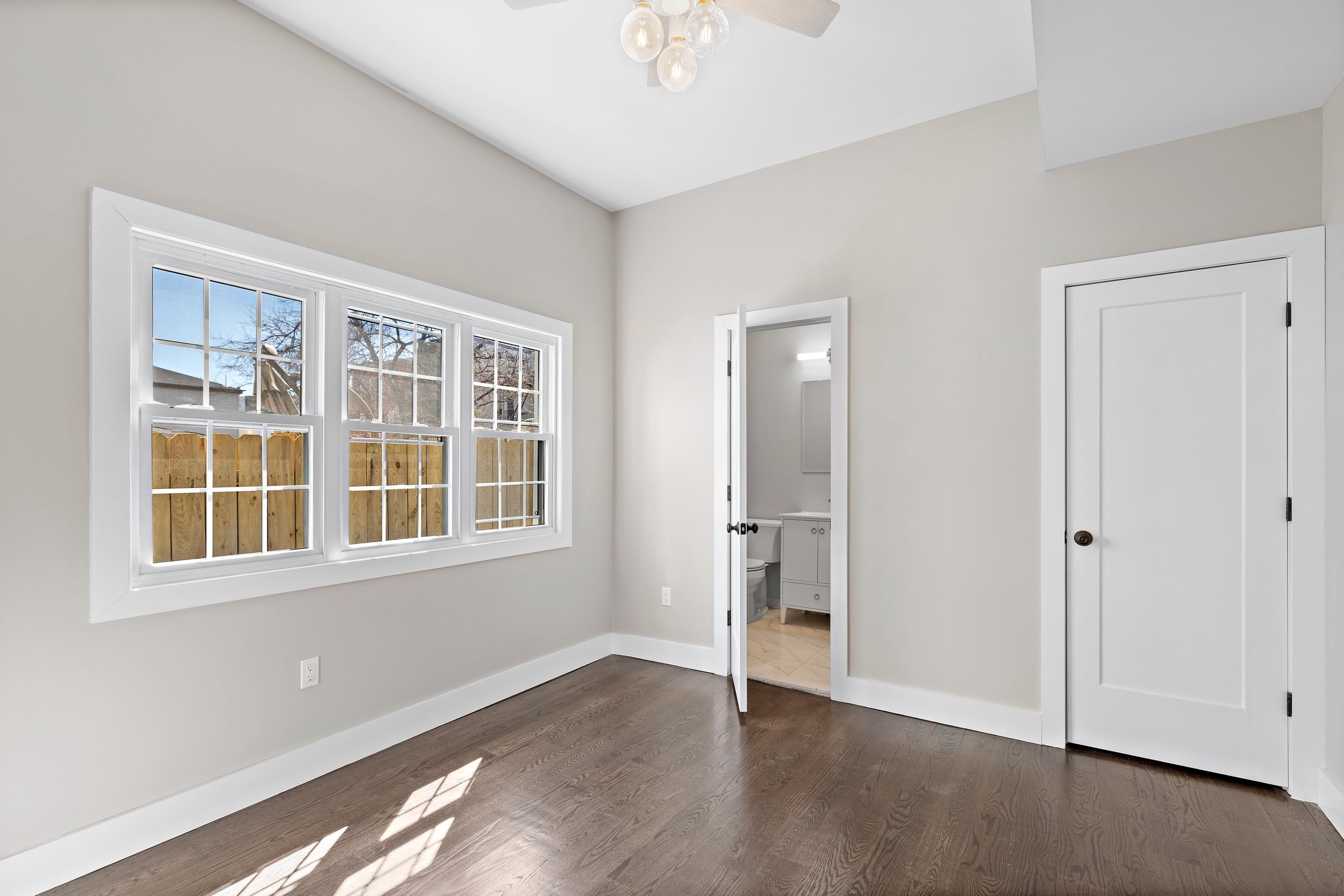 189 Hackensack Plank Road Weehawken, NJ 07086 - Photo 28 of 46 a view of an empty room with wooden floor and a window
