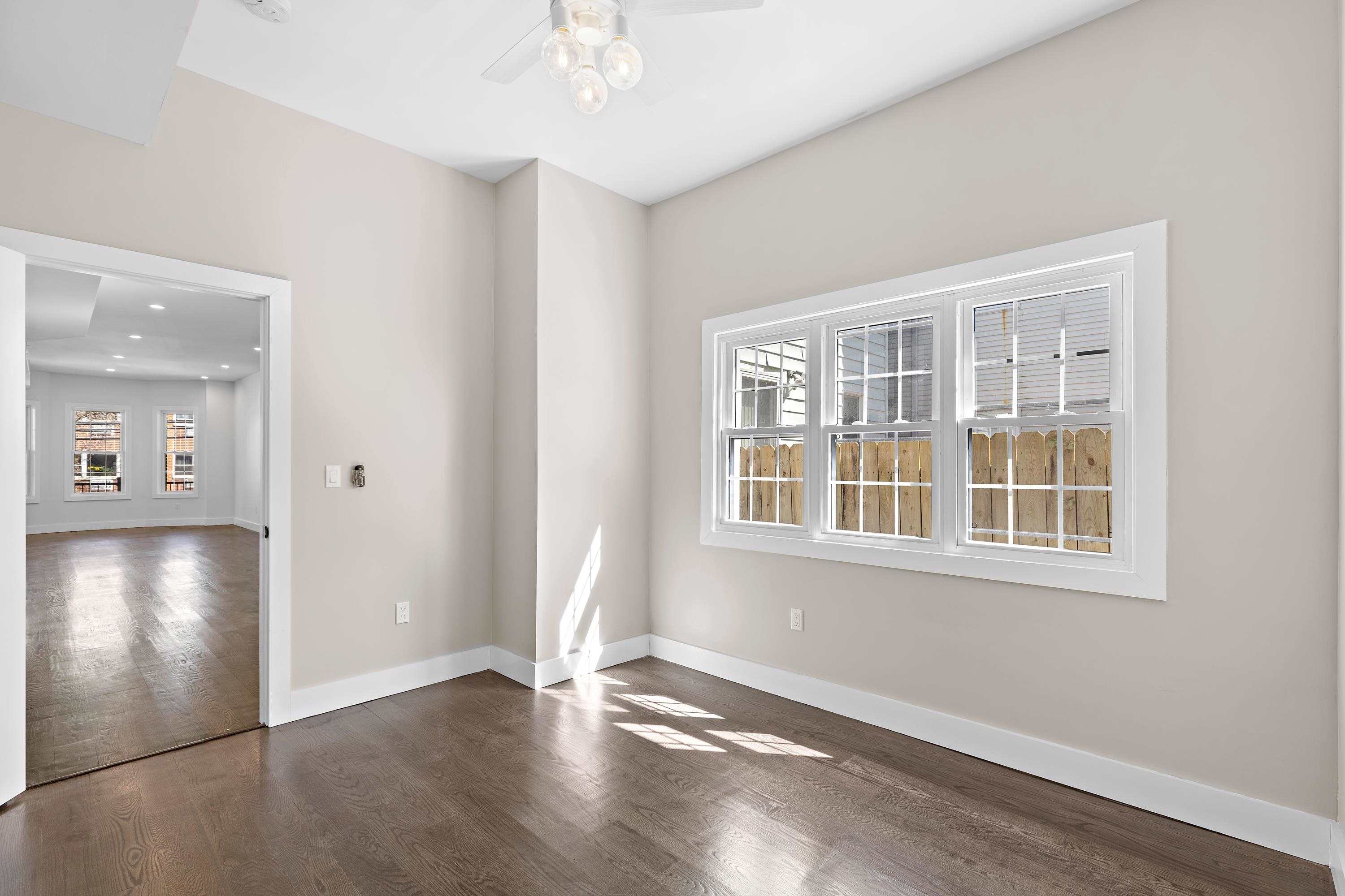 189 Hackensack Plank Road Weehawken, NJ 07086 - Photo 29 of 46 an empty room with wooden floor and windows