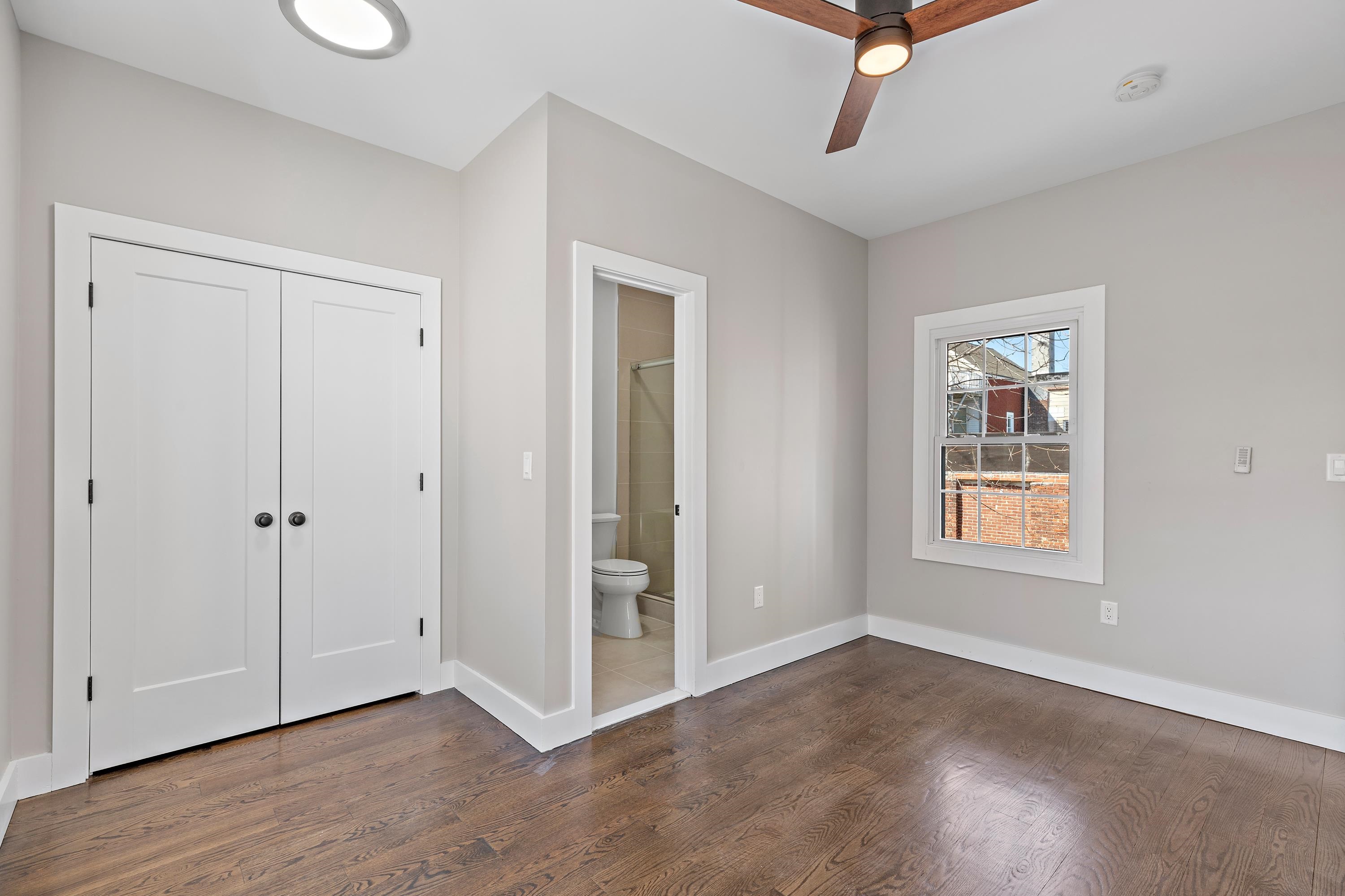 189 Hackensack Plank Road Weehawken, NJ 07086 - Photo 30 of 46 a view of an empty room with wooden floor and a window