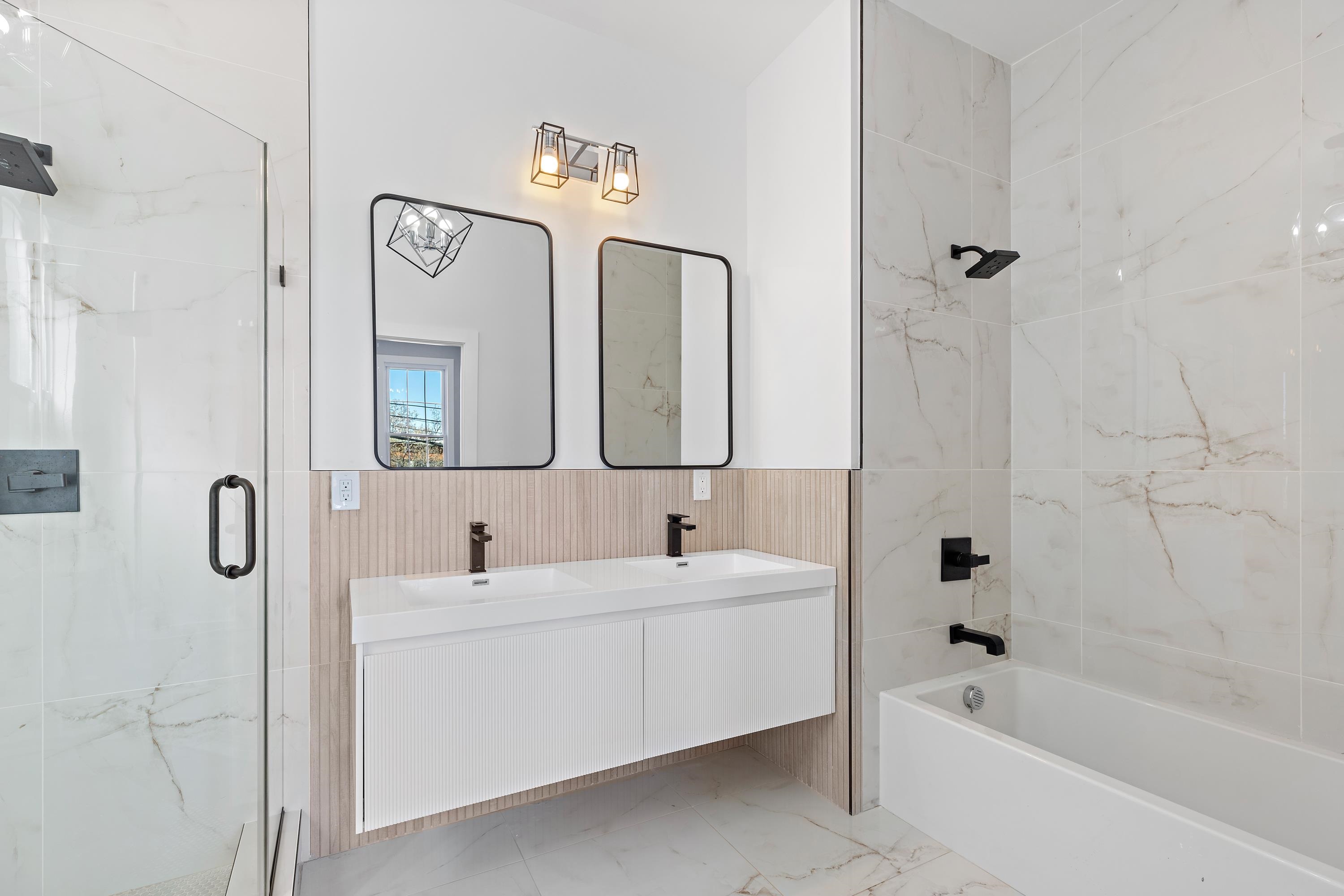 189 Hackensack Plank Road Weehawken, NJ 07086 - Photo 37 of 46 a bathroom with a double vanity sink mirror and bathtub