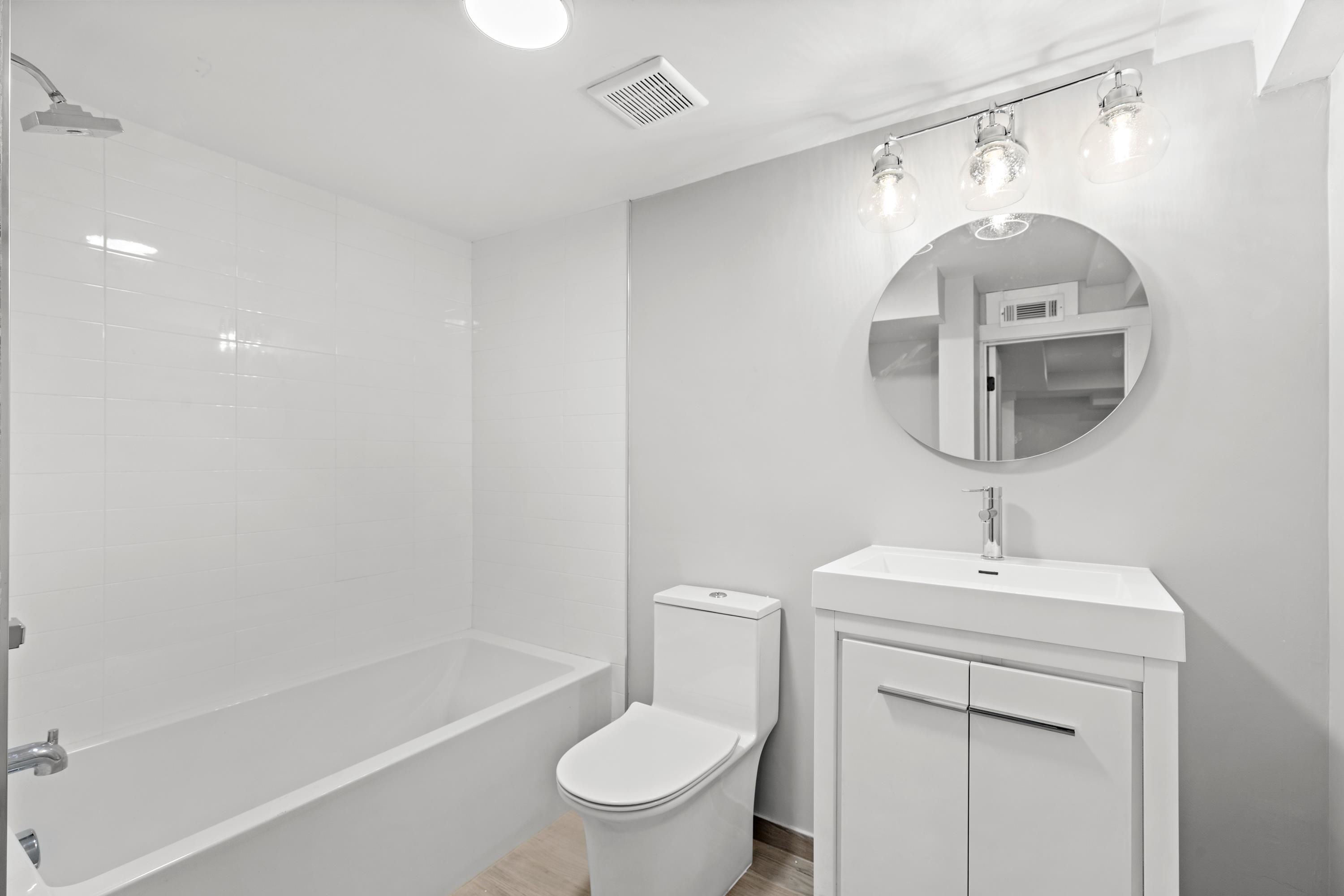 189 Hackensack Plank Road Weehawken, NJ 07086 - Photo 40 of 46 a bathroom with a toilet a sink and mirror