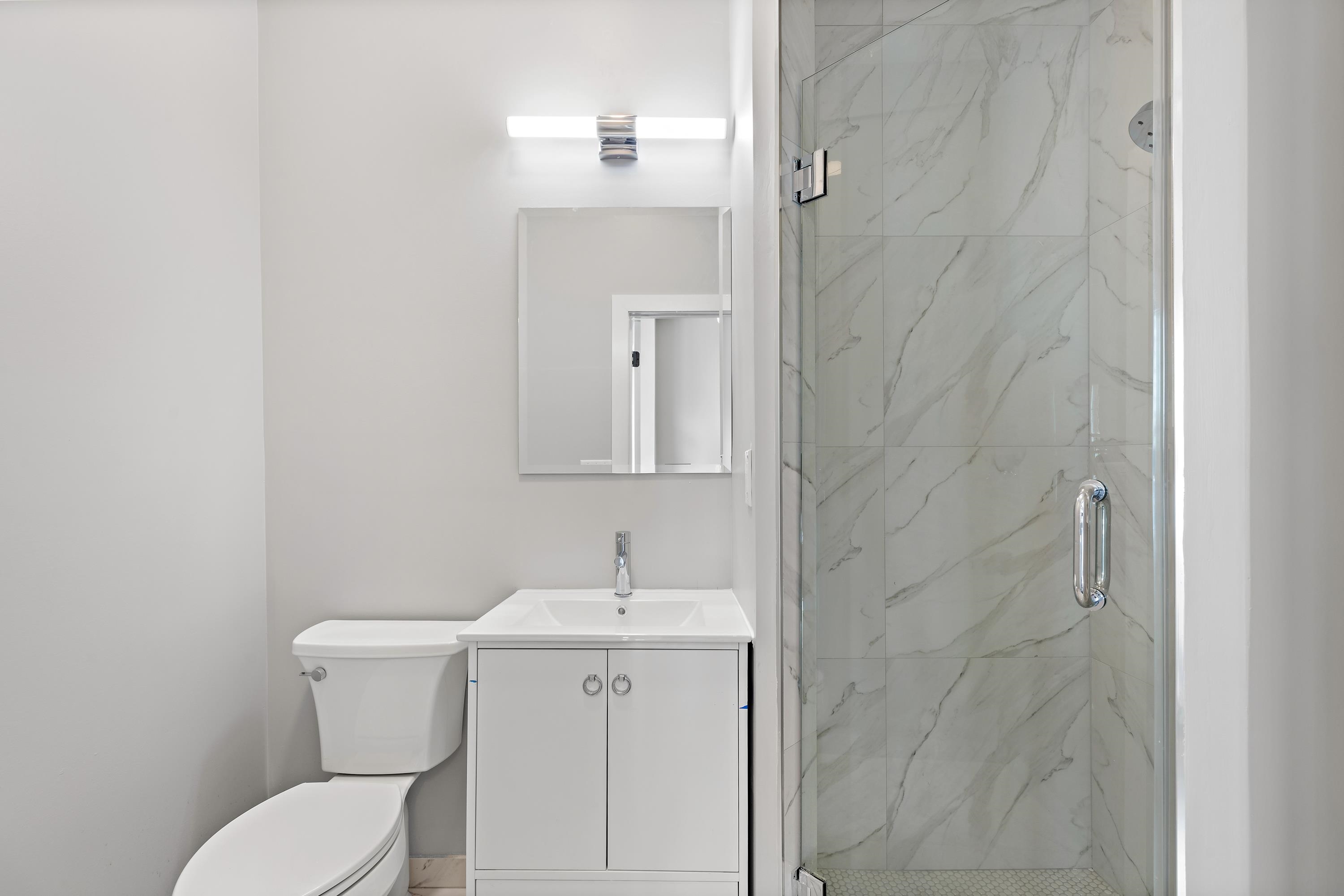 189 Hackensack Plank Road Weehawken, NJ 07086 - Photo 41 of 46 a bathroom with a toilet sink and mirror