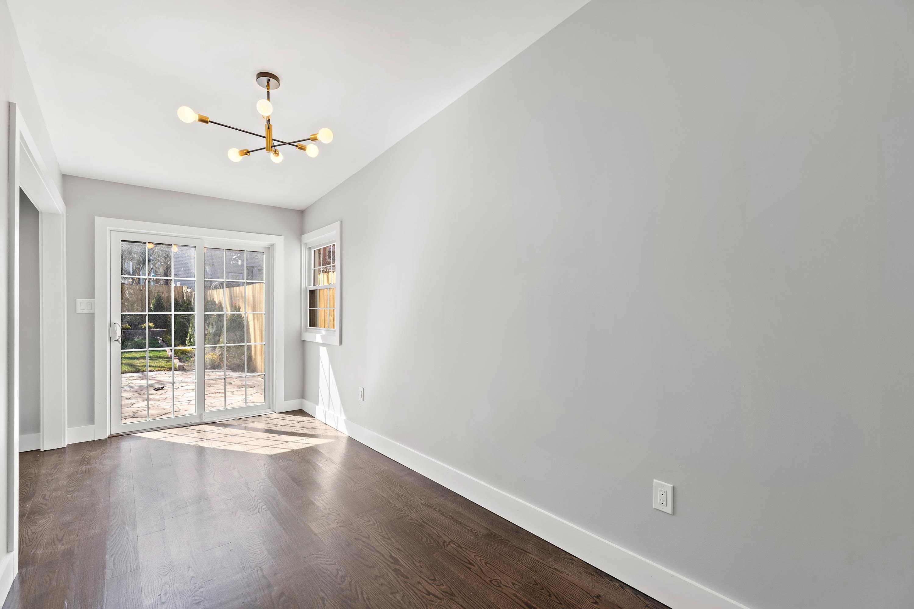 189 Hackensack Plank Road Weehawken, NJ 07086 - Photo 8 of 46 an empty room with wooden floor fan and windows