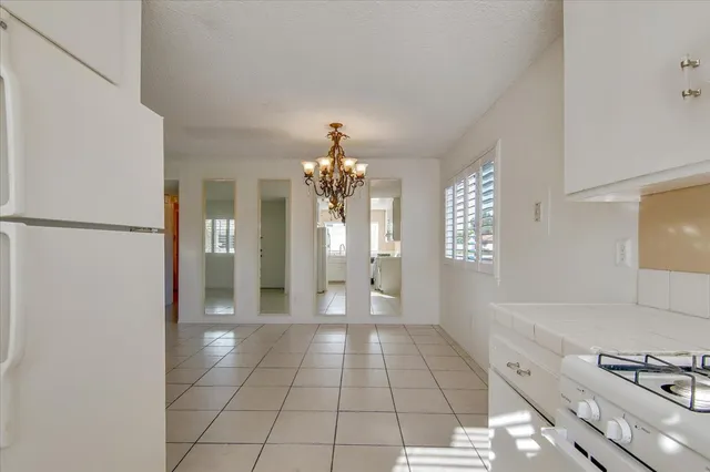 a view of a kitchen with an empty space and a window