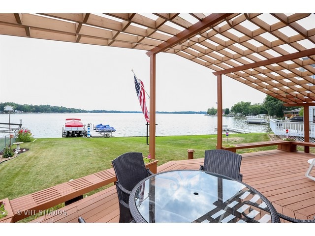 151 Eagle Point Road Fox Lake, IL 60020 - Photo 2 of 11 a view of swimming pool with a table and chairs next to yard