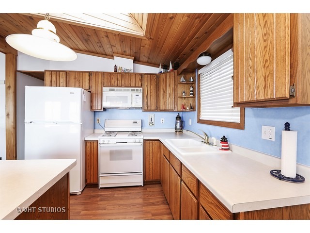 151 Eagle Point Road Fox Lake, IL 60020 - Photo 4 of 11 a kitchen with a sink cabinets and window