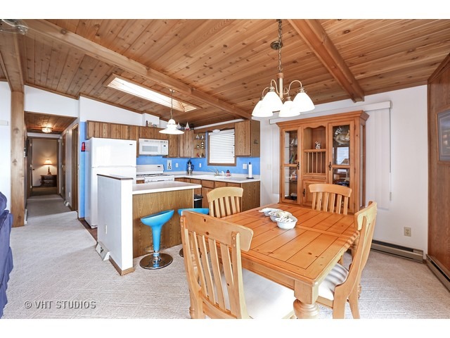 151 Eagle Point Road Fox Lake, IL 60020 - Photo 5 of 11 a dining room with stainless steel appliances kitchen island granite countertop a refrigerator a stove a sink dishwasher and a dining table with the view of kitchen