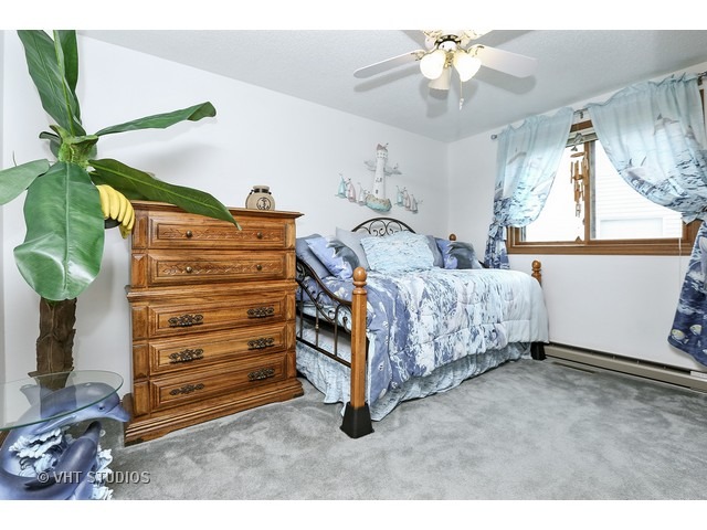 151 Eagle Point Road Fox Lake, IL 60020 - Photo 7 of 11 a bedroom with a bed and a chandelier