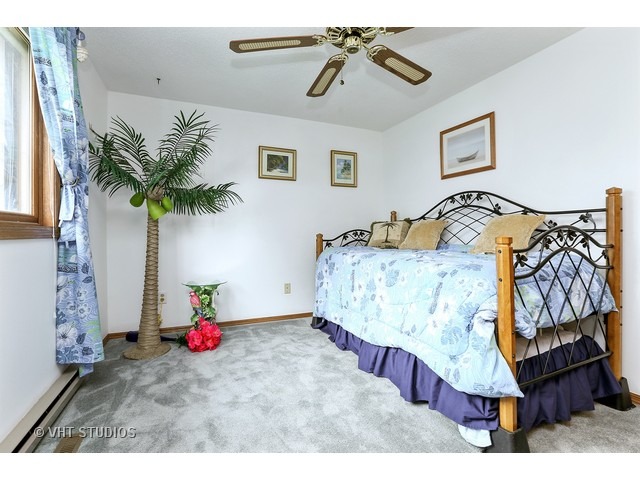 151 Eagle Point Road Fox Lake, IL 60020 - Photo 8 of 11 a bedroom with a bed and a chandelier