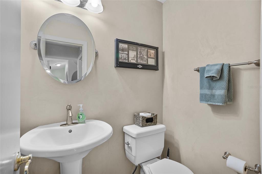 14612 Bray Road Orlando, FL 32832 - Photo 14 of 33 a bathroom with a toilet sink and mirror