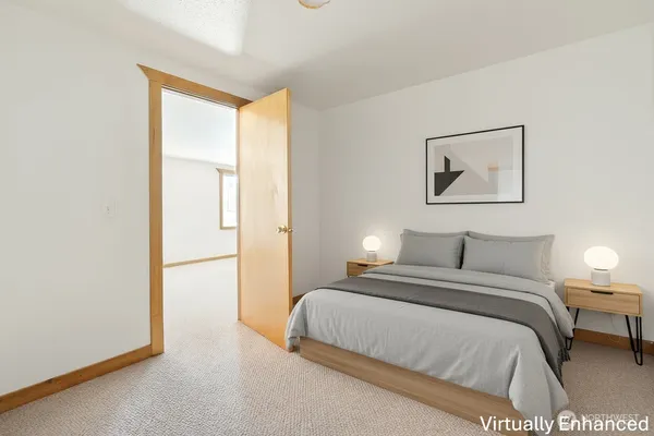 a bedroom with a bed and a painting on the wall