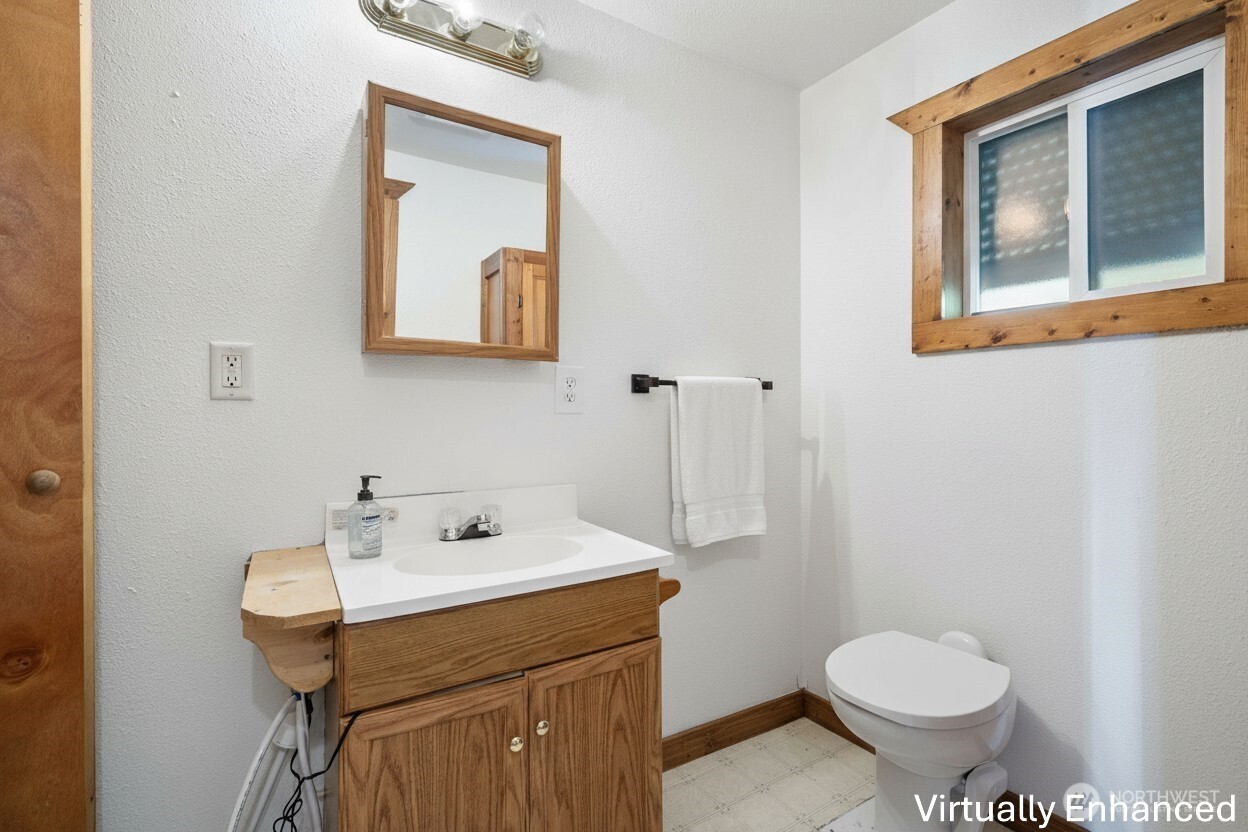 39217 Orville Road East Eatonville, WA 98328 - Photo 16 of 29 a bathroom with a sink toilet and mirror