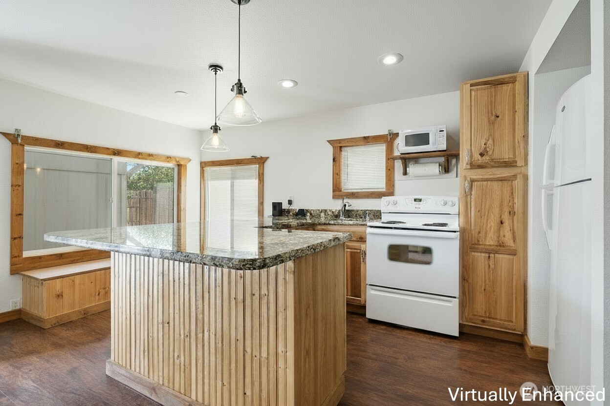 39217 Orville Road East Eatonville, WA 98328 - Photo 6 of 29 a kitchen that has a lot of white cabinets and stainless steel appliances
