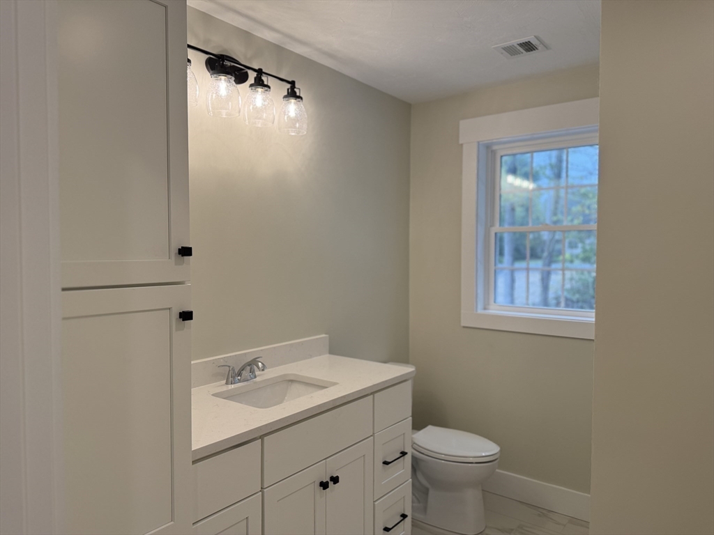 480 Wareham Street, Unit 2 Middleboro, MA 02346 - Photo 14 of 19 a bathroom with a sink toilet and vanity