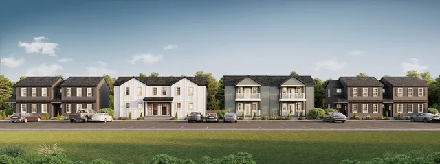 a front view of residential houses with yard and green space