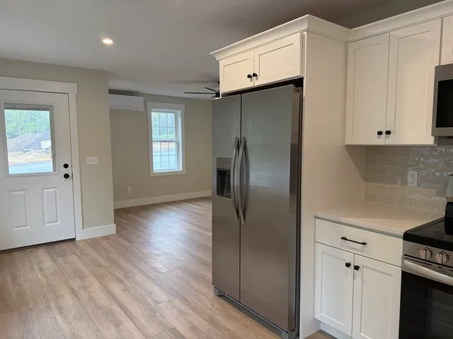 a kitchen with stainless steel appliances a refrigerator sink and cabinets