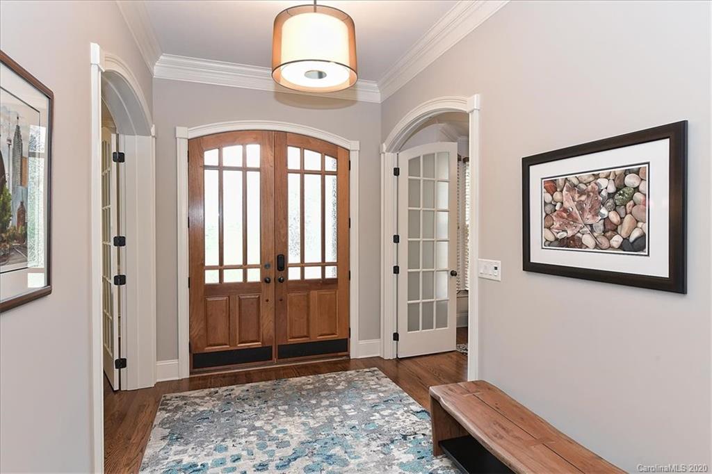 944 Bridlepath Lane Charlotte, NC 28211 - Photo 2 of 48 a view of a hallway with wooden floor and a rug