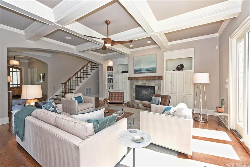 944 Bridlepath Lane Charlotte, NC 28211 - Photo 11 of 48 a living room with furniture a fireplace and a ceiling fan