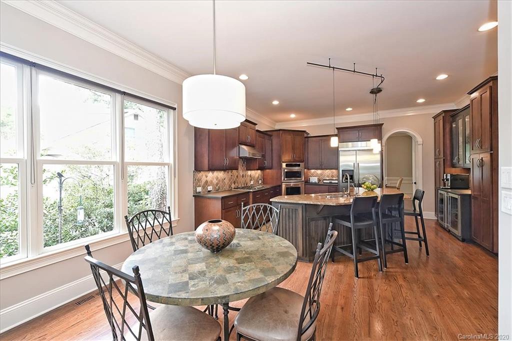 944 Bridlepath Lane Charlotte, NC 28211 - Photo 14 of 48 a view of a dining room with furniture window and wooden floor