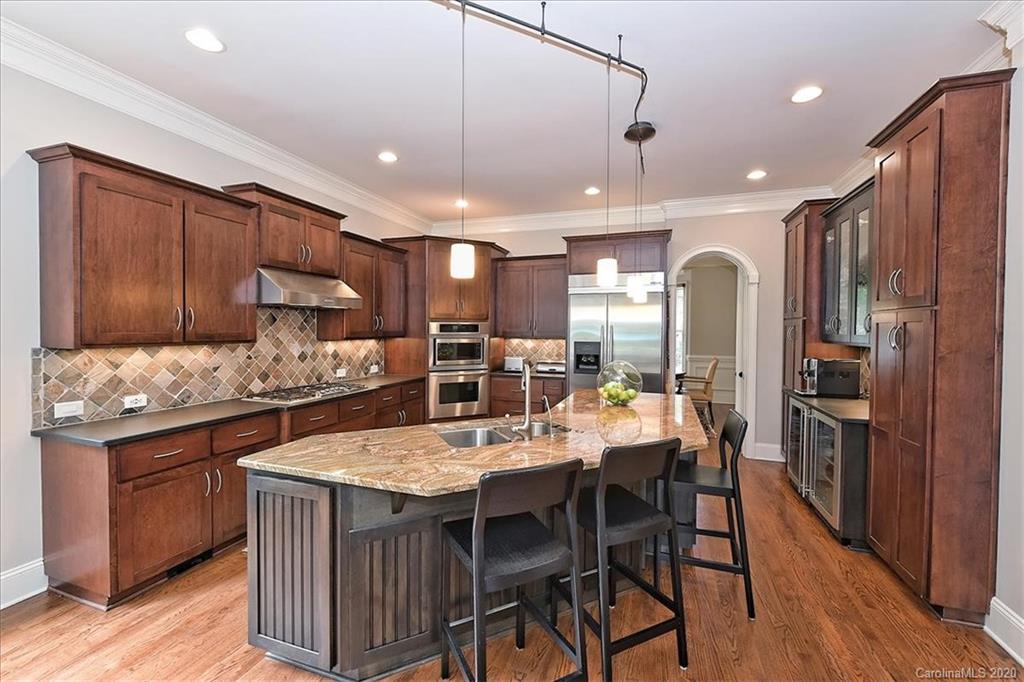 944 Bridlepath Lane Charlotte, NC 28211 - Photo 15 of 48 a kitchen with a table and chairs in it