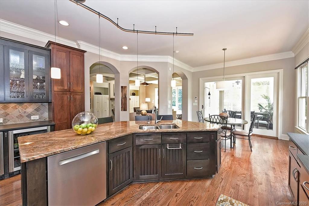 944 Bridlepath Lane Charlotte, NC 28211 - Photo 18 of 48 a kitchen with a sink and wooden cabinets