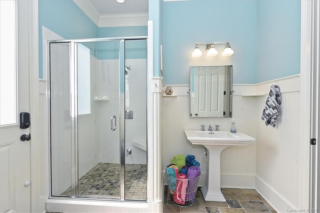 944 Bridlepath Lane Charlotte, NC 28211 - Photo 23 of 48 a bathroom with a sink mirror and shower