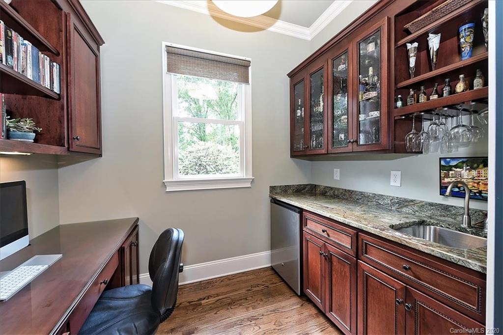 944 Bridlepath Lane Charlotte, NC 28211 - Photo 27 of 48 a kitchen with a sink cabinets and wooden floor