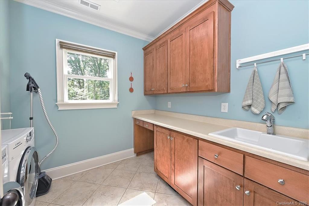 944 Bridlepath Lane Charlotte, NC 28211 - Photo 28 of 48 a room with a sink cabinets and a window