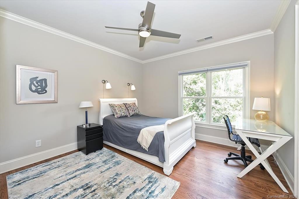944 Bridlepath Lane Charlotte, NC 28211 - Photo 34 of 48 a living room with a bed furniture and a window