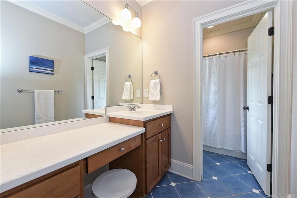 944 Bridlepath Lane Charlotte, NC 28211 - Photo 35 of 48 a bathroom with a sink a toilet and mirror