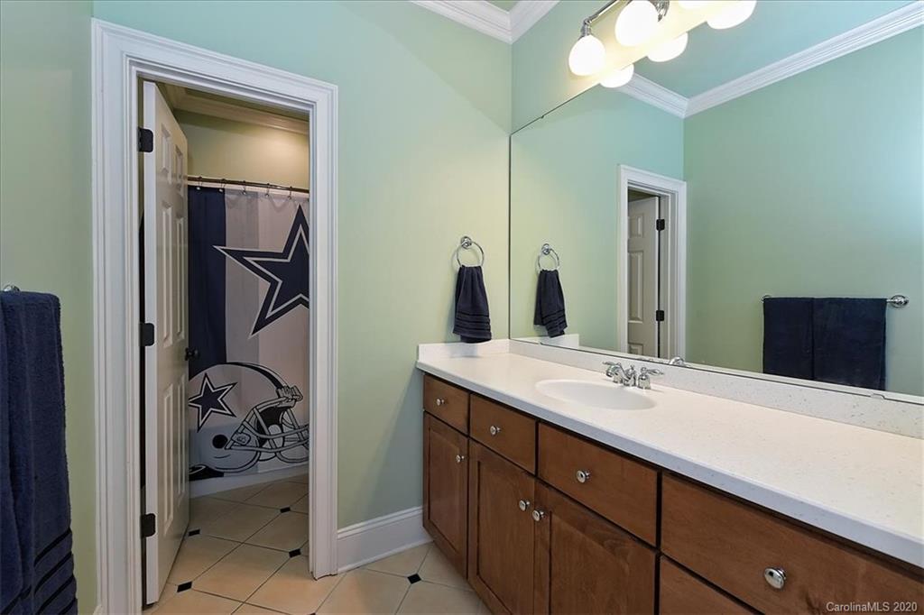 944 Bridlepath Lane Charlotte, NC 28211 - Photo 37 of 48 a en suite bathroom with a sink and a mirror