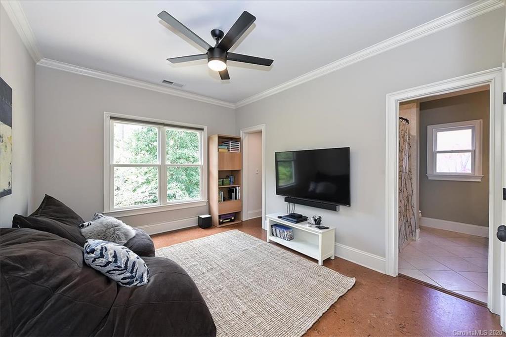 944 Bridlepath Lane Charlotte, NC 28211 - Photo 38 of 48 a bedroom with a bed television on desk and a window