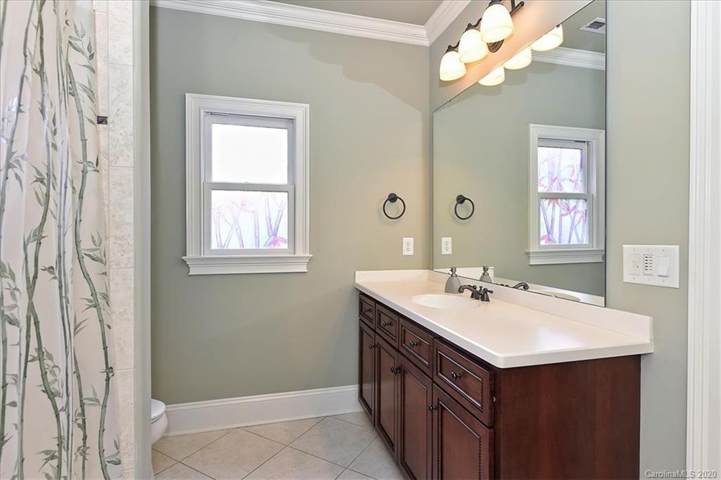 944 Bridlepath Lane Charlotte, NC 28211 - Photo 39 of 48 a bathroom with a sink a vanity and a mirror