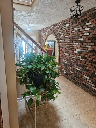 a potted plant sitting in front of a brick building
