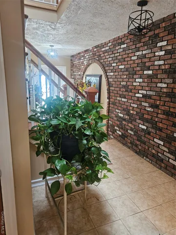 a potted plant sitting in front of a brick building