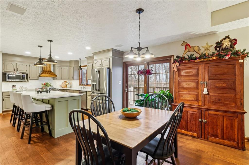 191 Castile Ridge Road Marianna, PA 15345 - Photo 21 of 50 a view of a dining room and livingroom with furniture wooden floor a chandelier