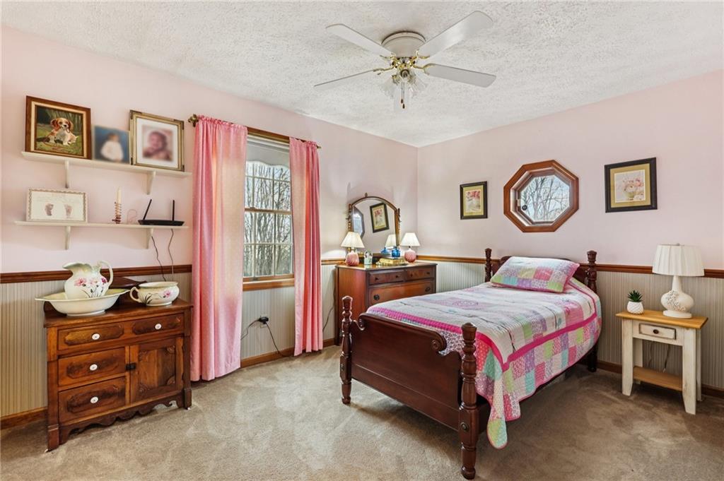 191 Castile Ridge Road Marianna, PA 15345 - Photo 25 of 50 a bedroom with a bed and a chandelier