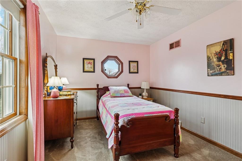 191 Castile Ridge Road Marianna, PA 15345 - Photo 26 of 50 a bedroom with a bed and a chandelier