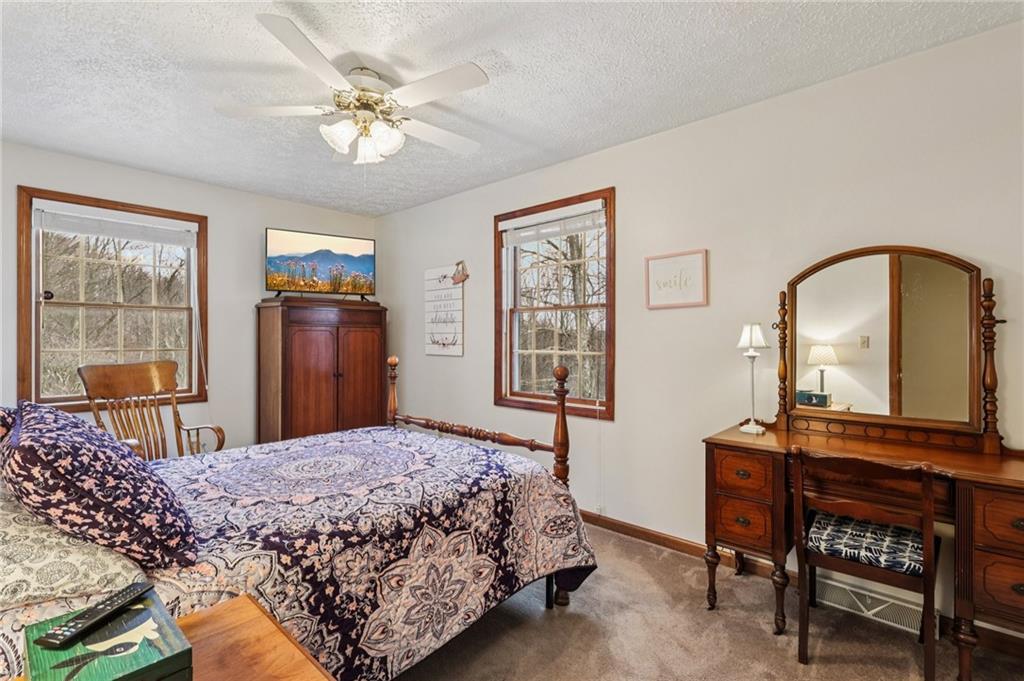 191 Castile Ridge Road Marianna, PA 15345 - Photo 28 of 50 a bedroom with a bed and a table with bookshelf