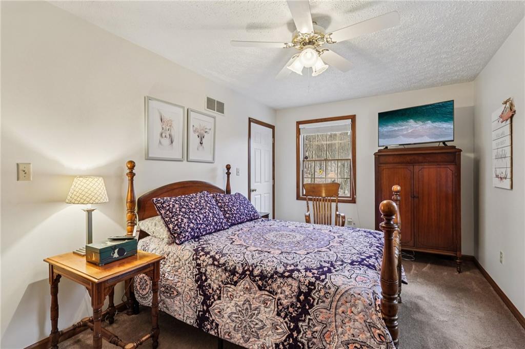 191 Castile Ridge Road Marianna, PA 15345 - Photo 29 of 50 a bedroom with a bed and a chandelier