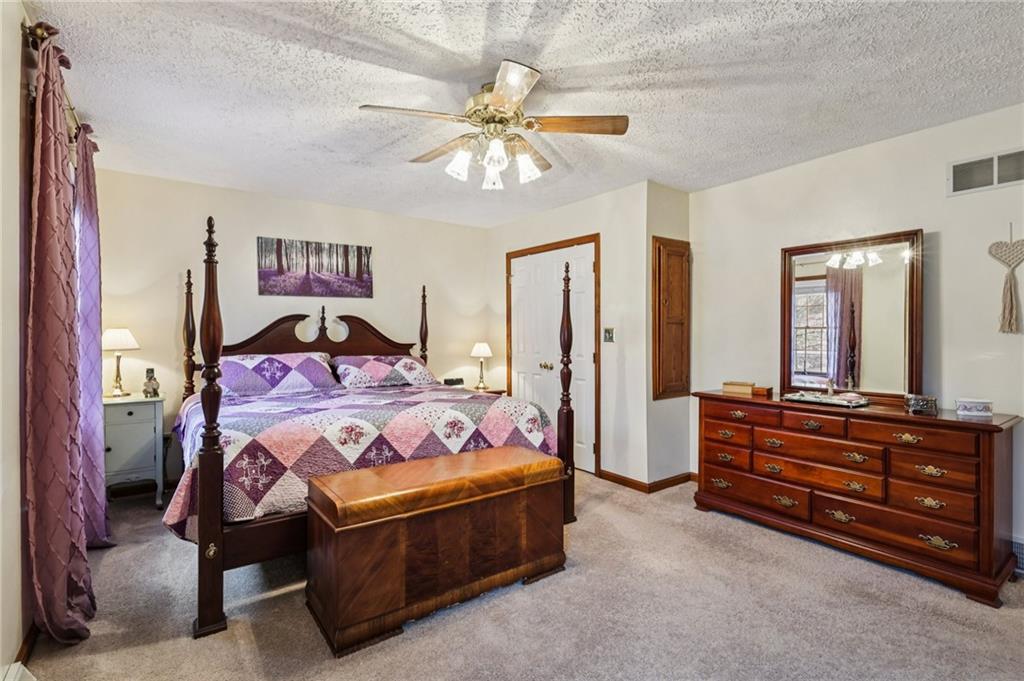 191 Castile Ridge Road Marianna, PA 15345 - Photo 30 of 50 a bedroom with a bed and a chandelier