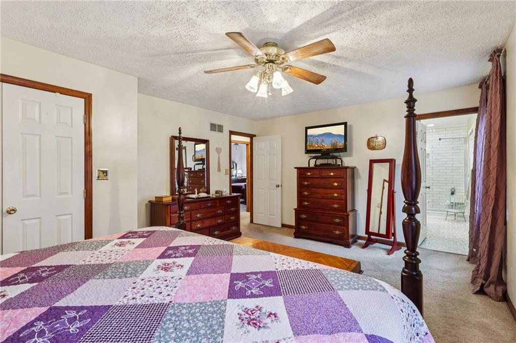 191 Castile Ridge Road Marianna, PA 15345 - Photo 32 of 50 a bedroom with a bed and a chandelier