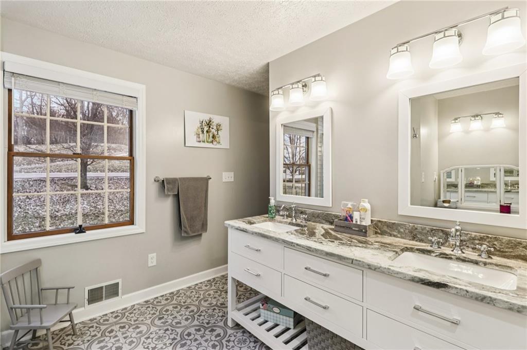 191 Castile Ridge Road Marianna, PA 15345 - Photo 34 of 50 a bathroom with a granite countertop sink and a mirror