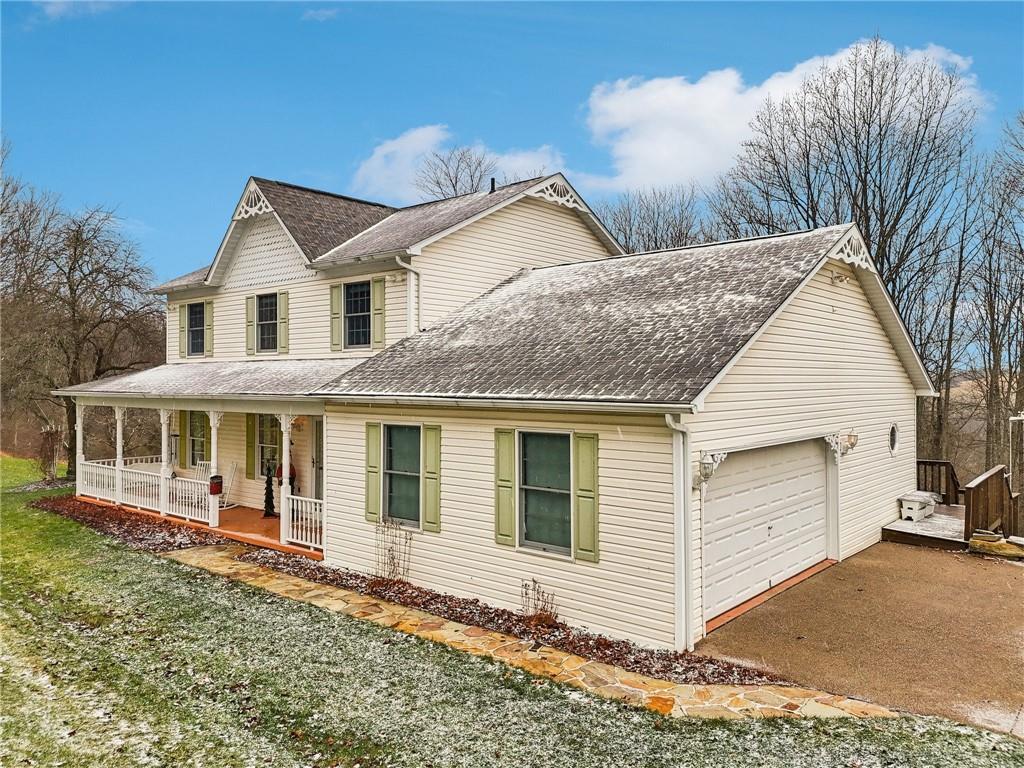 191 Castile Ridge Road Marianna, PA 15345 - Photo 46 of 50 a view of a white house with large windows next to a yard