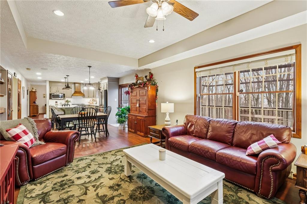 191 Castile Ridge Road Marianna, PA 15345 - Photo 9 of 50 a living room with furniture a rug and a chandelier