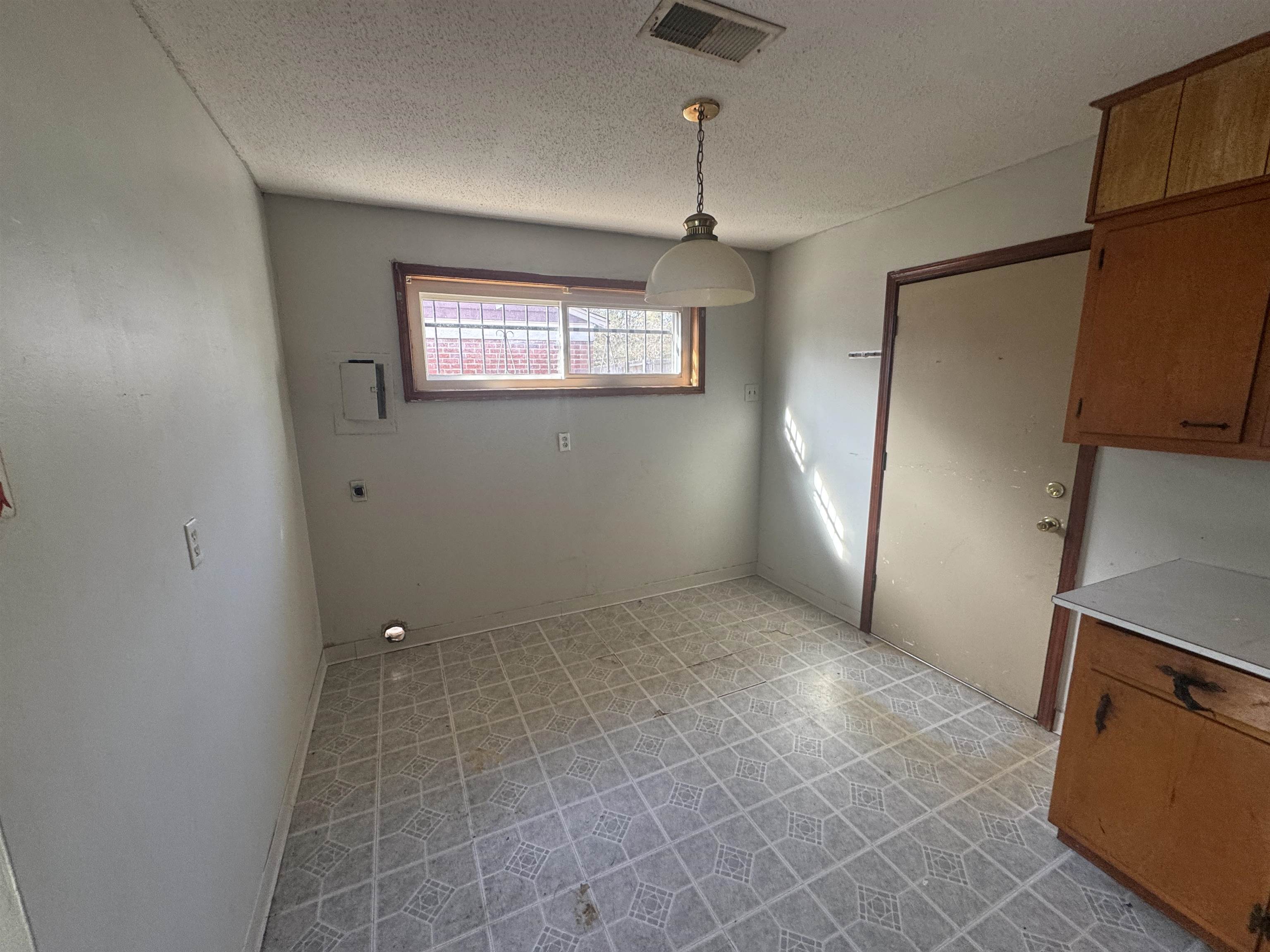 256 Delta Road Memphis, TN 38109 - Photo 12 of 22 Unfurnished dining area featuring a textured ceiling and light flooring
