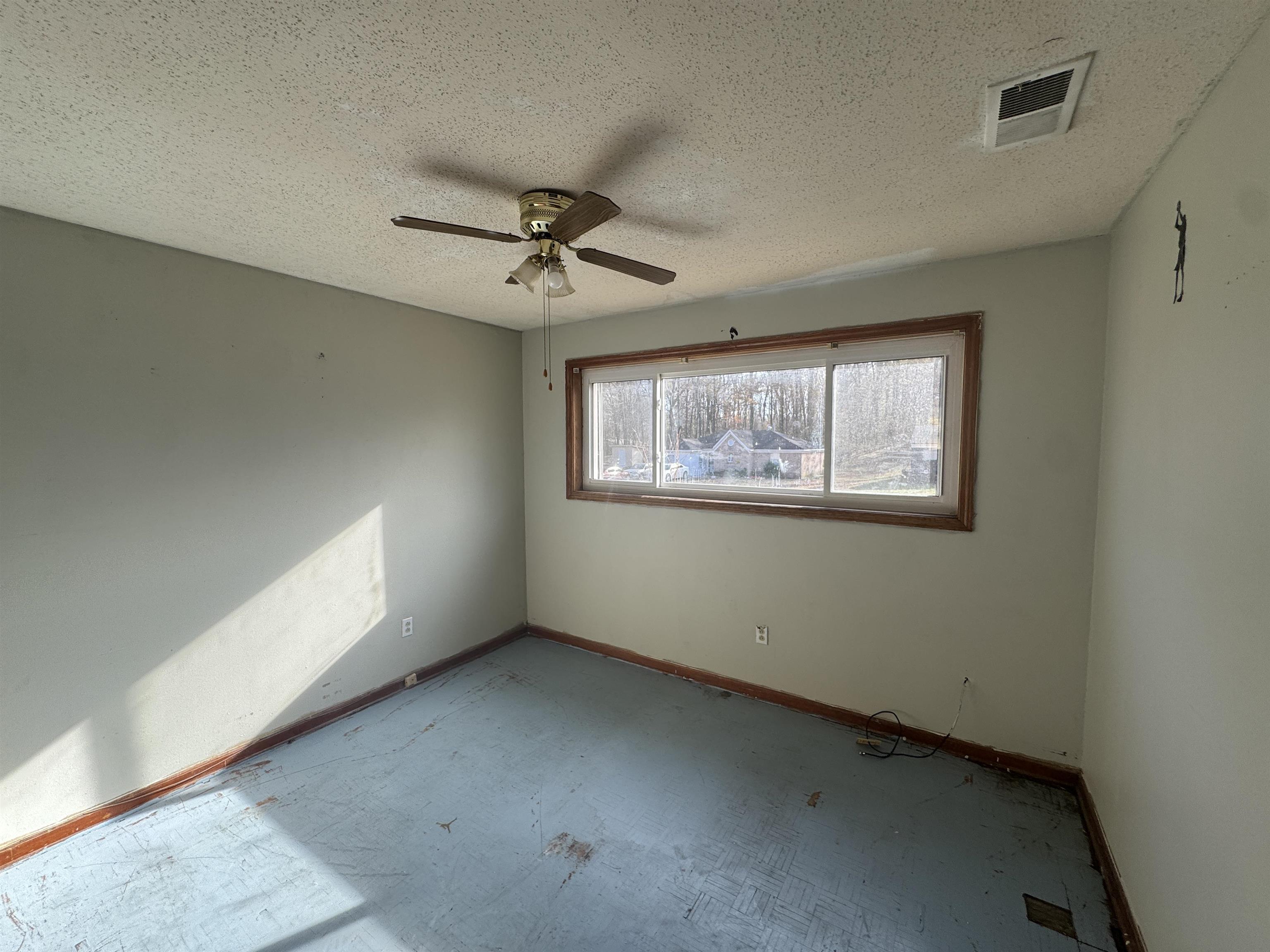 256 Delta Road Memphis, TN 38109 - Photo 18 of 22 Spare room featuring a ceiling fan and a textured ceiling