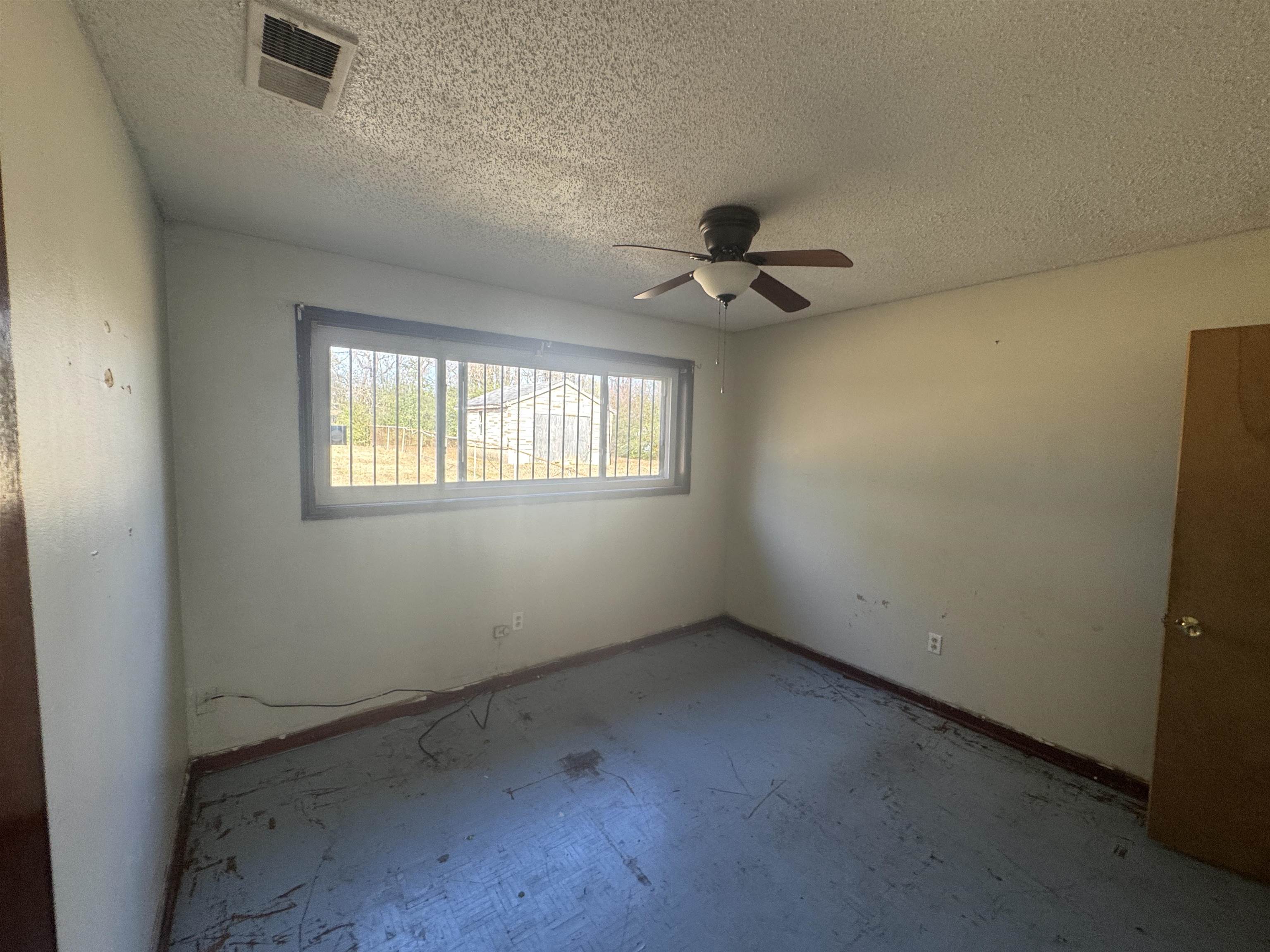 256 Delta Road Memphis, TN 38109 - Photo 19 of 22 Empty room featuring a ceiling fan and a textured ceiling