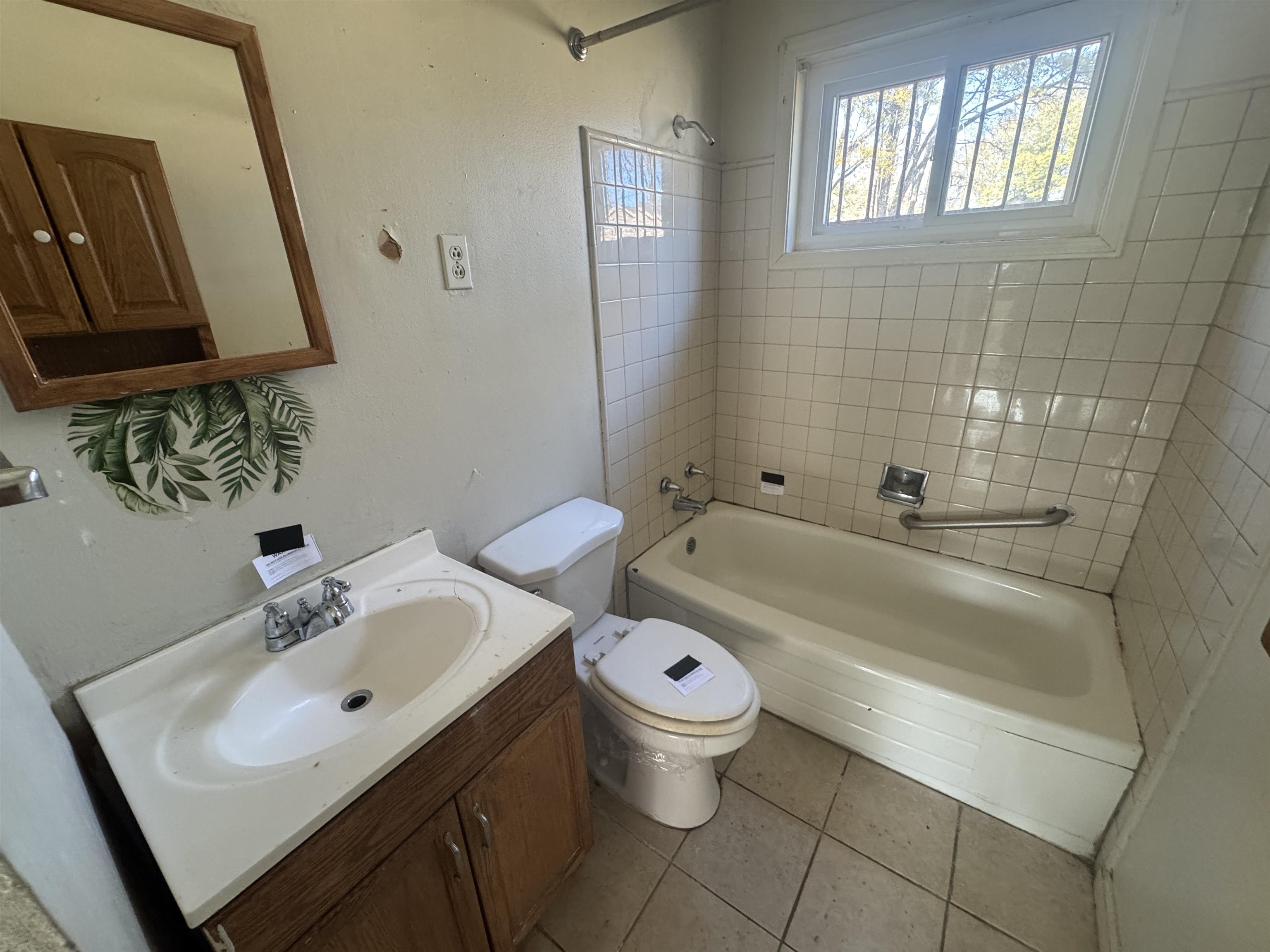 256 Delta Road Memphis, TN 38109 - Photo 21 of 22 Bathroom with vanity, shower / washtub combination, and light tile patterned floors